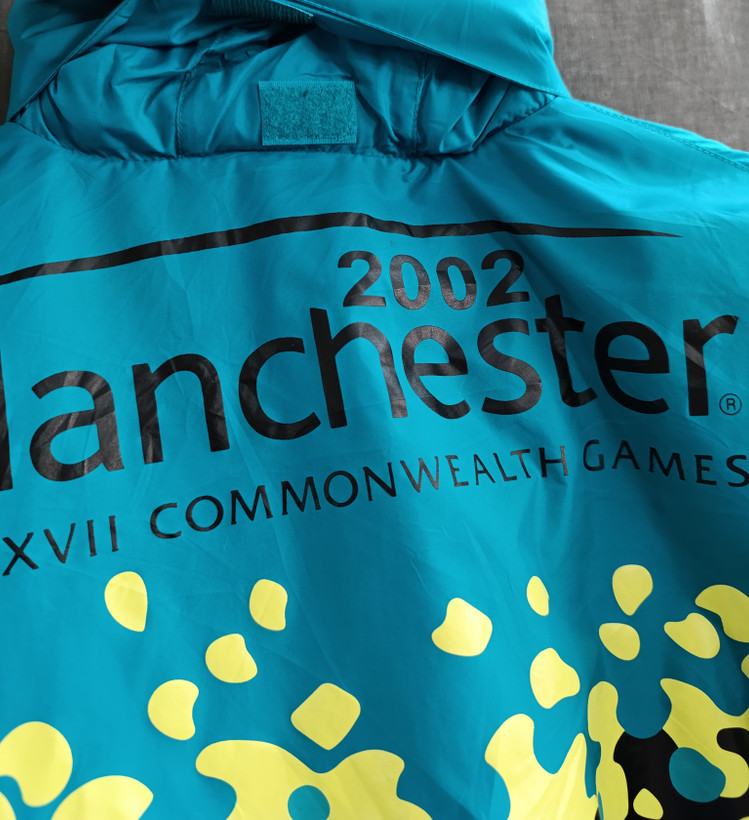 بادگیر مردانه اورجینال Manchester 2002 | کاپشن سبک ضدباد با طراحی مسابقات Commonwealth Games